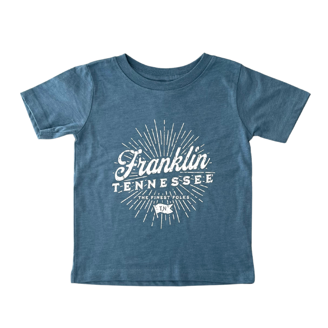 Blue toddler shirt says, "Franklin Tennessee The Finest Folks" screen-printed in white. 
