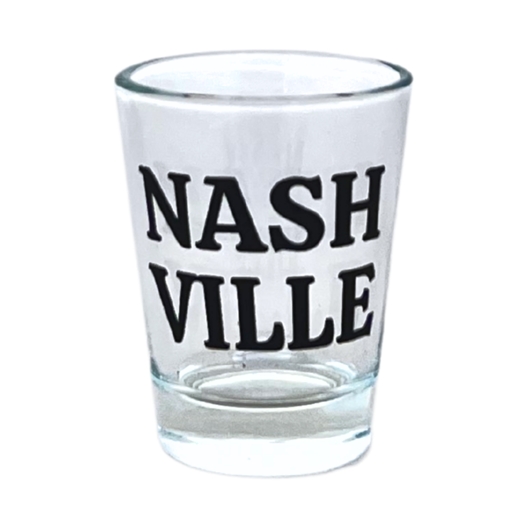 Standard 1 oz shot glass, designed in Nashville, Tennessee. Features "Nashville" in black on a clear shot glass.