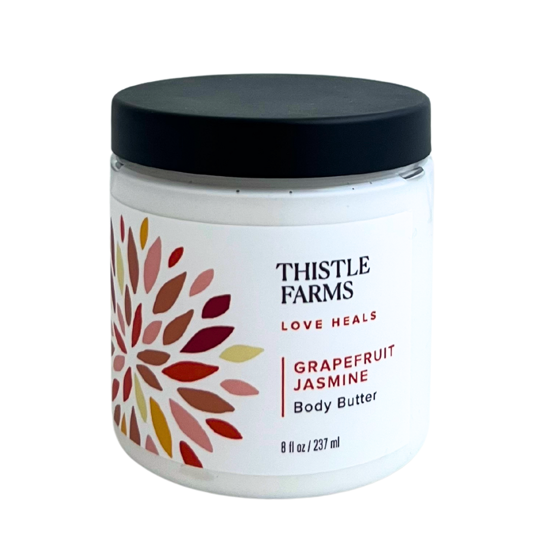 8 oz Thistle Farms Body Butter in Grapefruit Jasmine, comes in plastic jar with lid. 