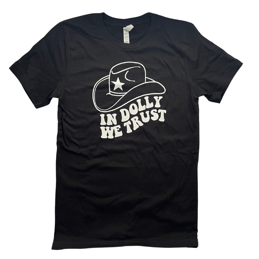 Black shirt says, "In Dolly We Trust" printed in white retro font with cowboy hat. 