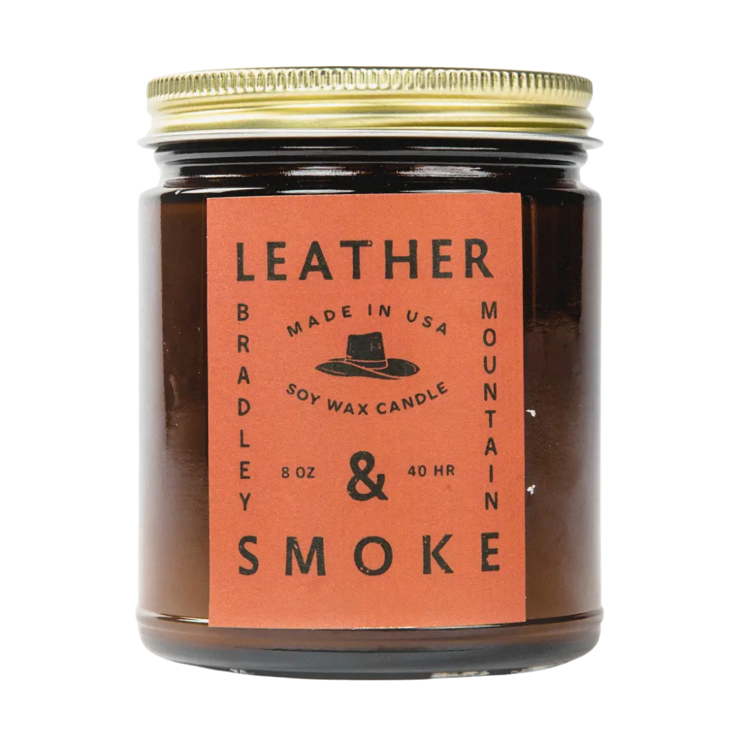 8 oz leather and smoke candle, bergamot, geranium, leather, clove, and tobacco in glass jar with lid.