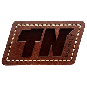 Approximately 3x3 leather parallelogram magnet. 