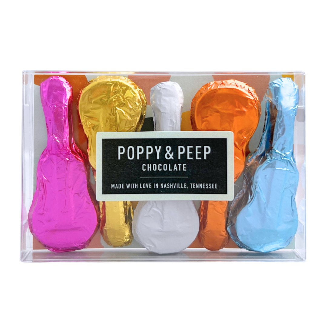 Set of 5 mini milk chocolate shaped guitars wrapped in assorted colored foil, measuring approx 3"x1" each, in clear box.