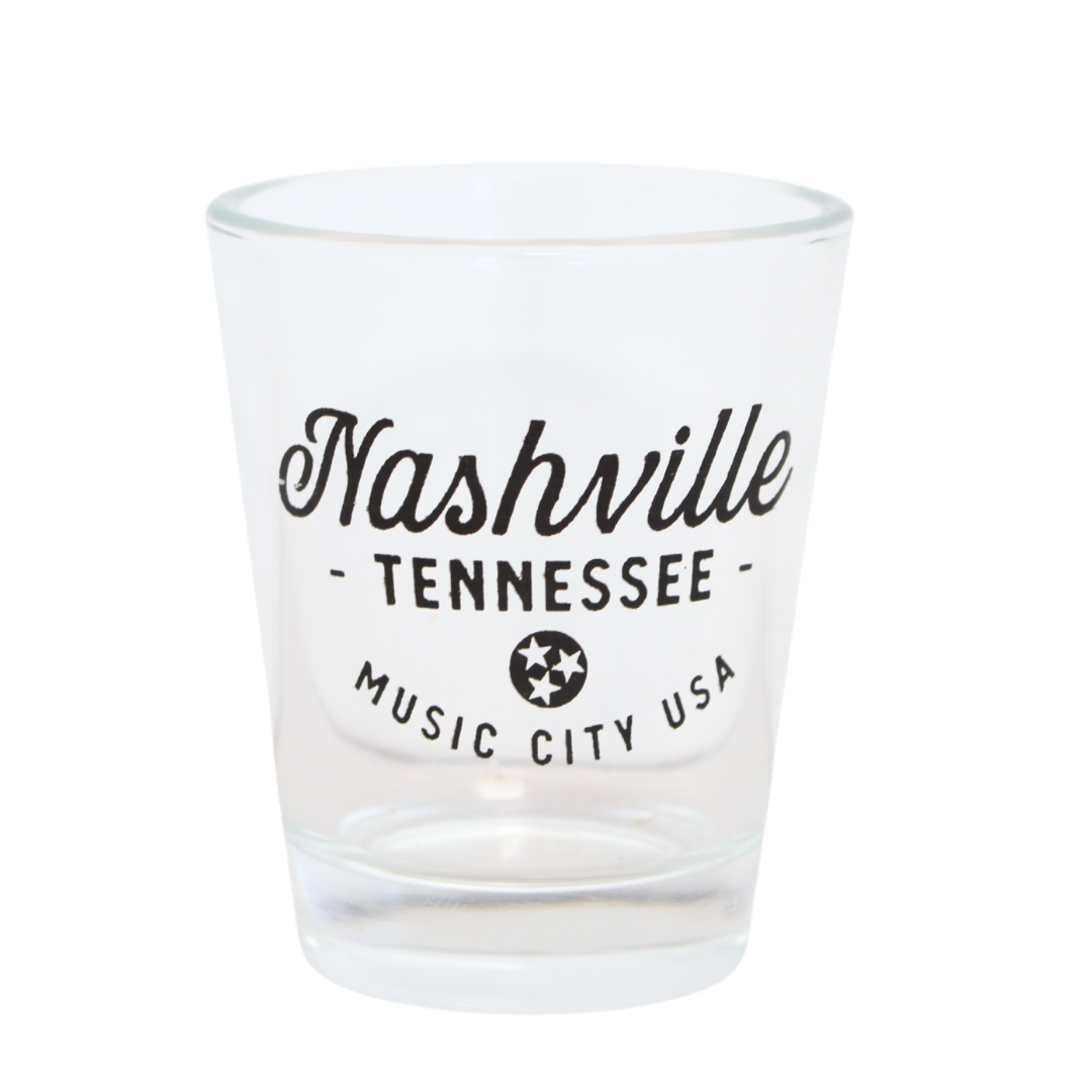 "Nashville, Tennessee" printed on a clear shot glass. Also features the tristar logo and music city USA printed below.