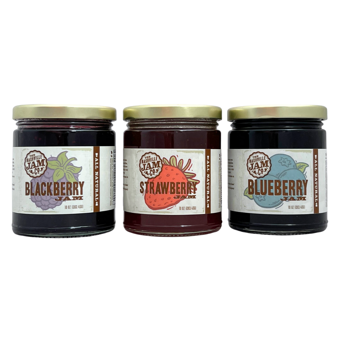Glass Jars of Blackberry Jam, Strawberry Jam and Blueberry Jam. 