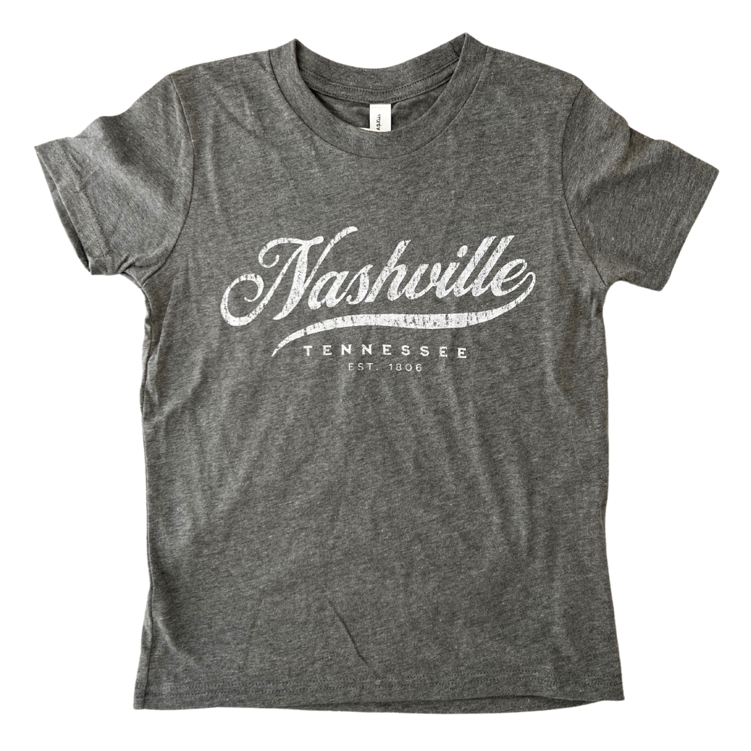 Grey youth shirt says, "Nashville Tennessee" screen-printed in white. 