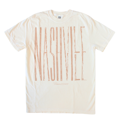 Cream shirt with Nashville printed in rustic styled oversized block lettering. 