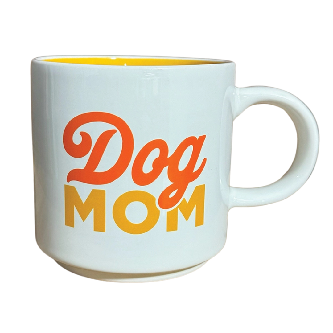"Dog Mom" mug. White mug with orange and red letters that say "Dog Mom".