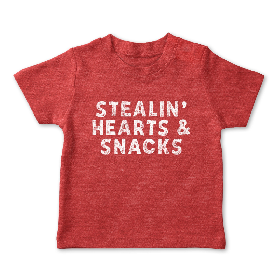 Red toddler shirt says, "Stealin' Hearts & Snacks" screen-printed in white. 