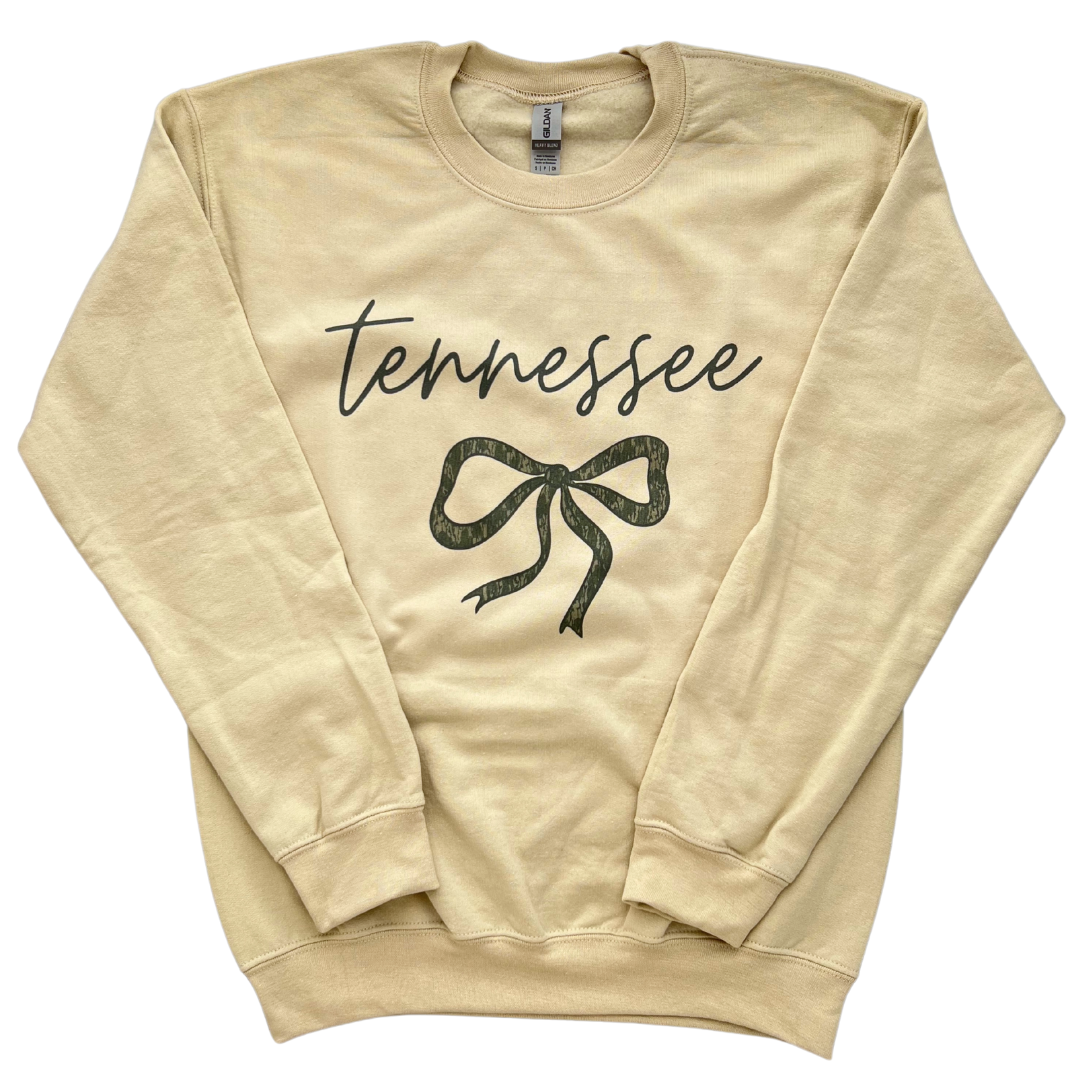 Tan crew neck sweatshirt says, "Tennessee" with camo bow. 