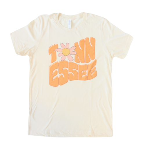 Cream Shirt with "Tennessee" in retro orange font with pink daisy. 