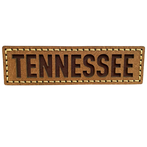 approximately 4x1 inch leather magnet with "Tennessee" in block letters. 