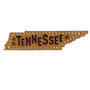 Approximately 4x1 inch leather magnet shaped like the state of Tennessee. 