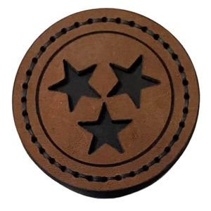 approximately 3 inch round leather magnet.  
