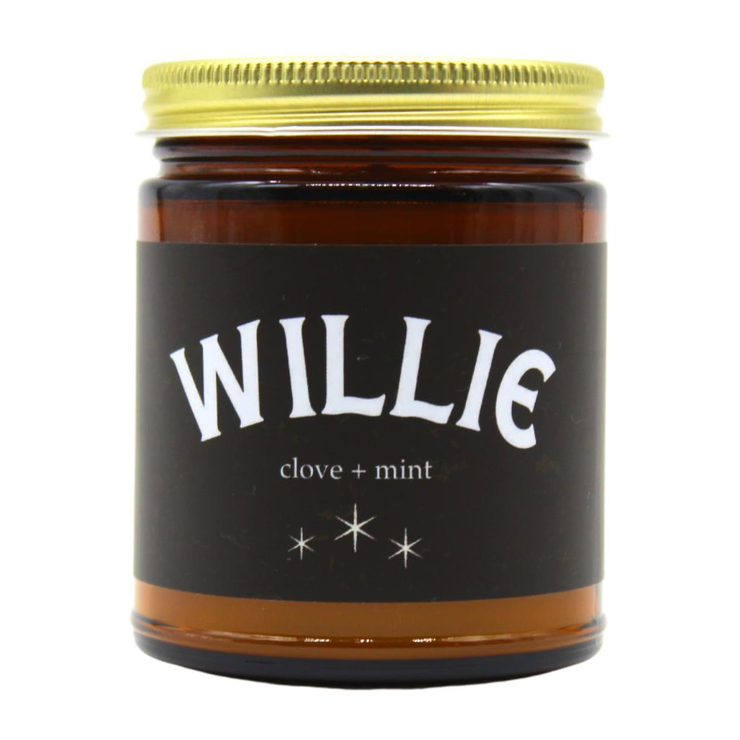 Willie Candle scented of clove and mint in a  amber glass jar with lid.  