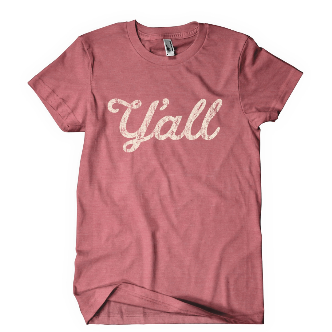 Dusty pink shirt says, "Y'all" screen-printed in white script. 