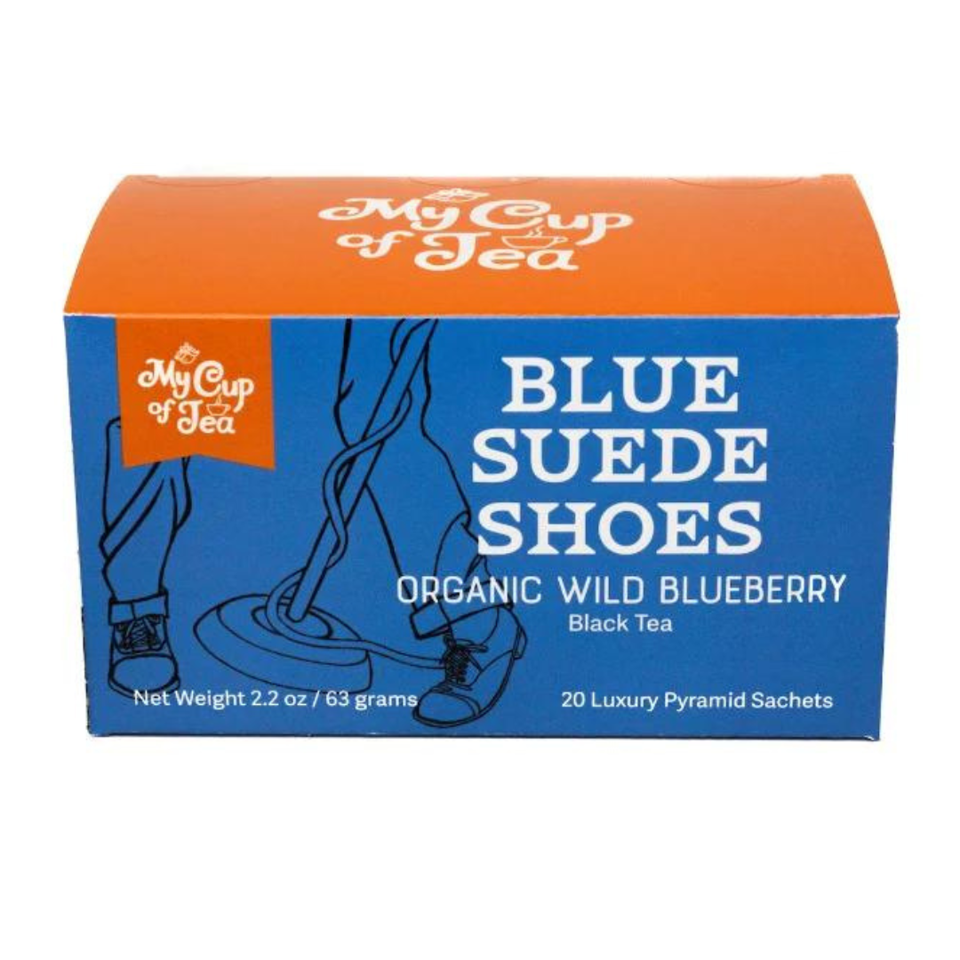 Box of tea. Art work shows somebody dancing with Blue Suede Shoes tangled around a mic stand. Black Tea. Company logo is on top.