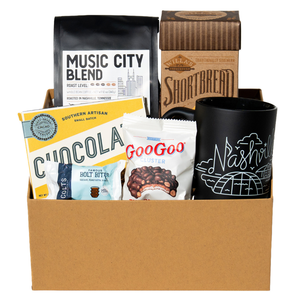 Collection of coffee, cookies, chocolates and a mug in full sized gift box. 