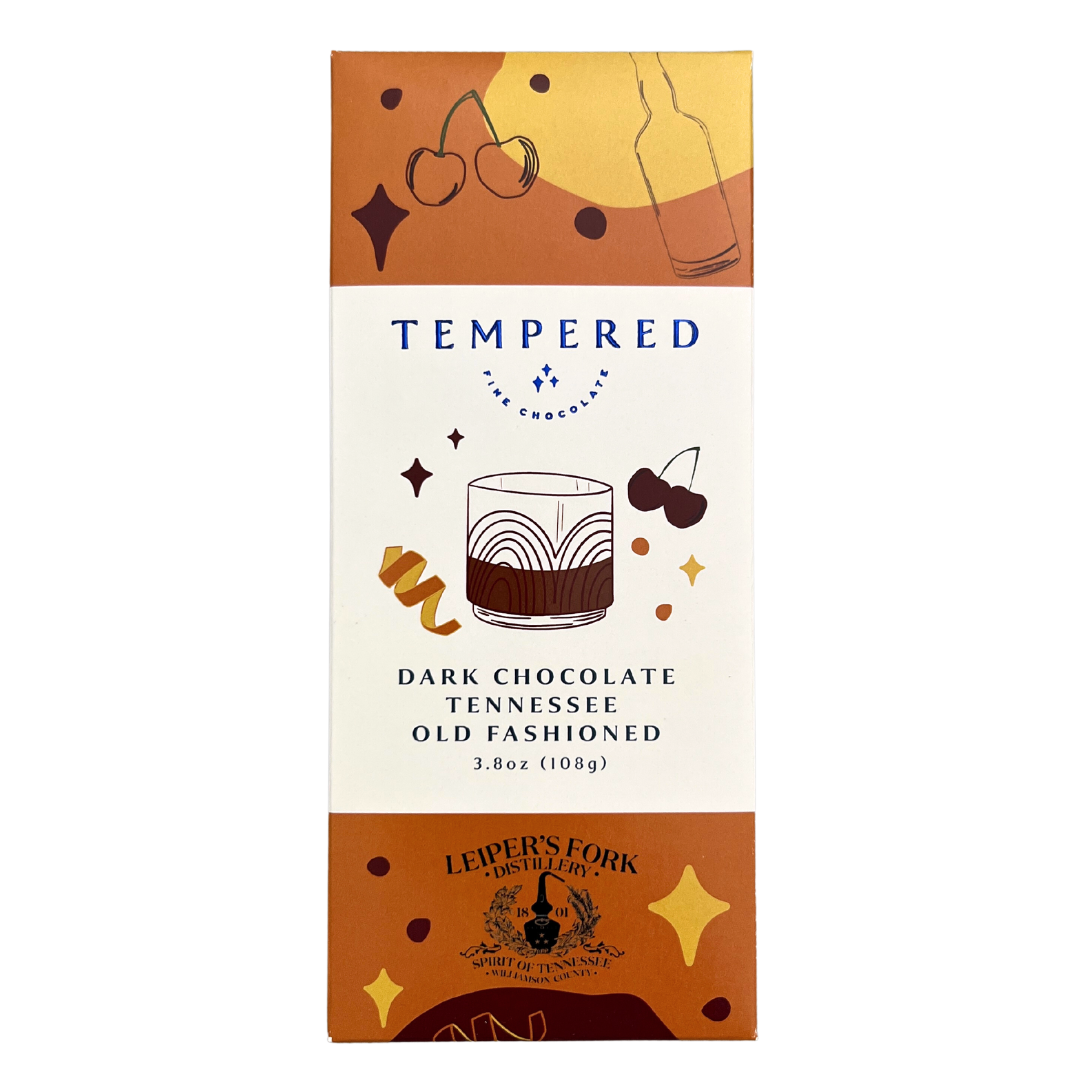 Tempered chocolate bar labeled 'Dark Chocolate Tennessee Old Fashioned' featuring cocktail and cherry illustrations, in collaboration with Leiper’s Fork Distillery.