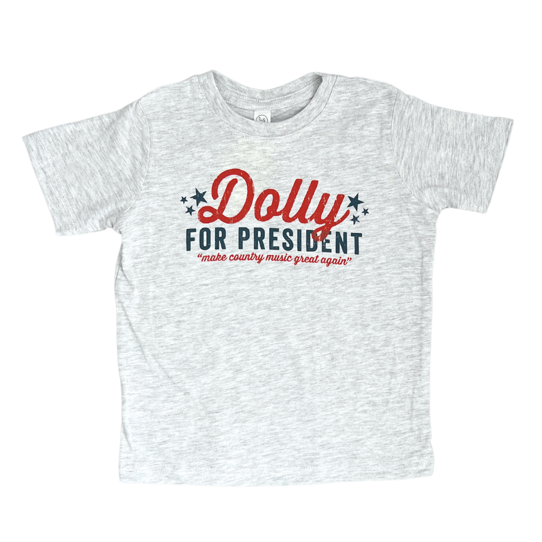 Grey toddler shirt says, "Dolly for President" in red and blue. 