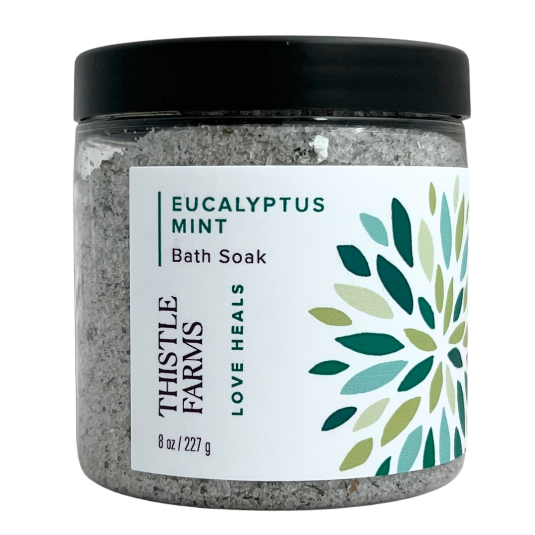 Eucalyptus Mint bath salts in 8 oz plastic jar with black lid green floral pattern on a white label. 
