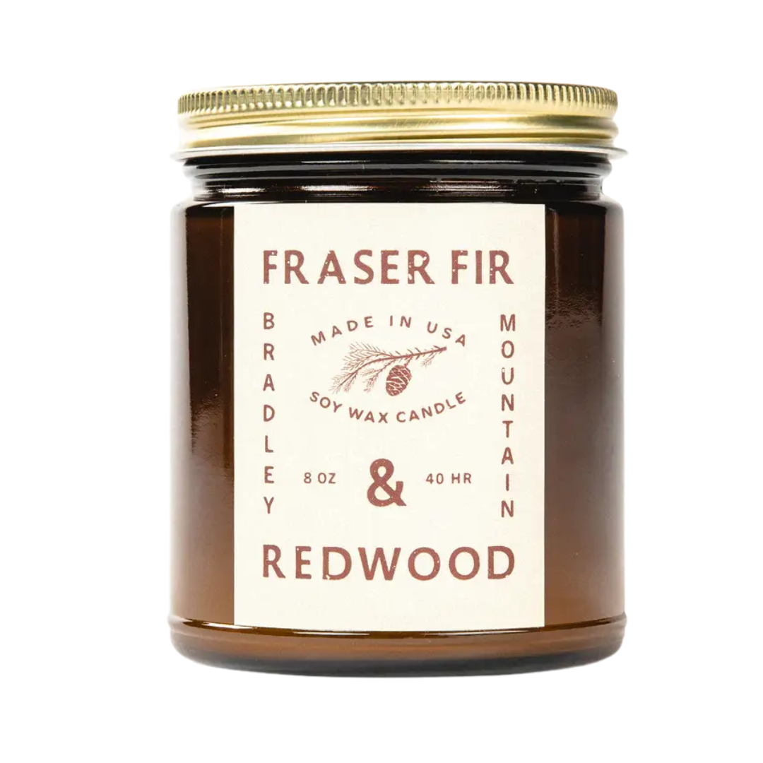 8 oz Fraser Fir and Redwood soy candle in amber jar with gold lid. 