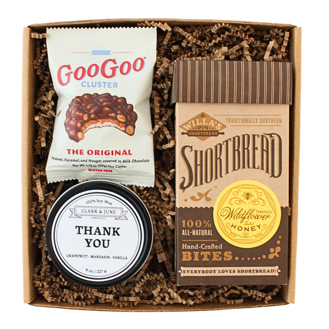 cookies and chocolates and a candle that says, "Thank you" in a gift box. 