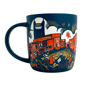 Mug featuring etched design of downtown Nashville. Blue mug with orange white and gold details.  