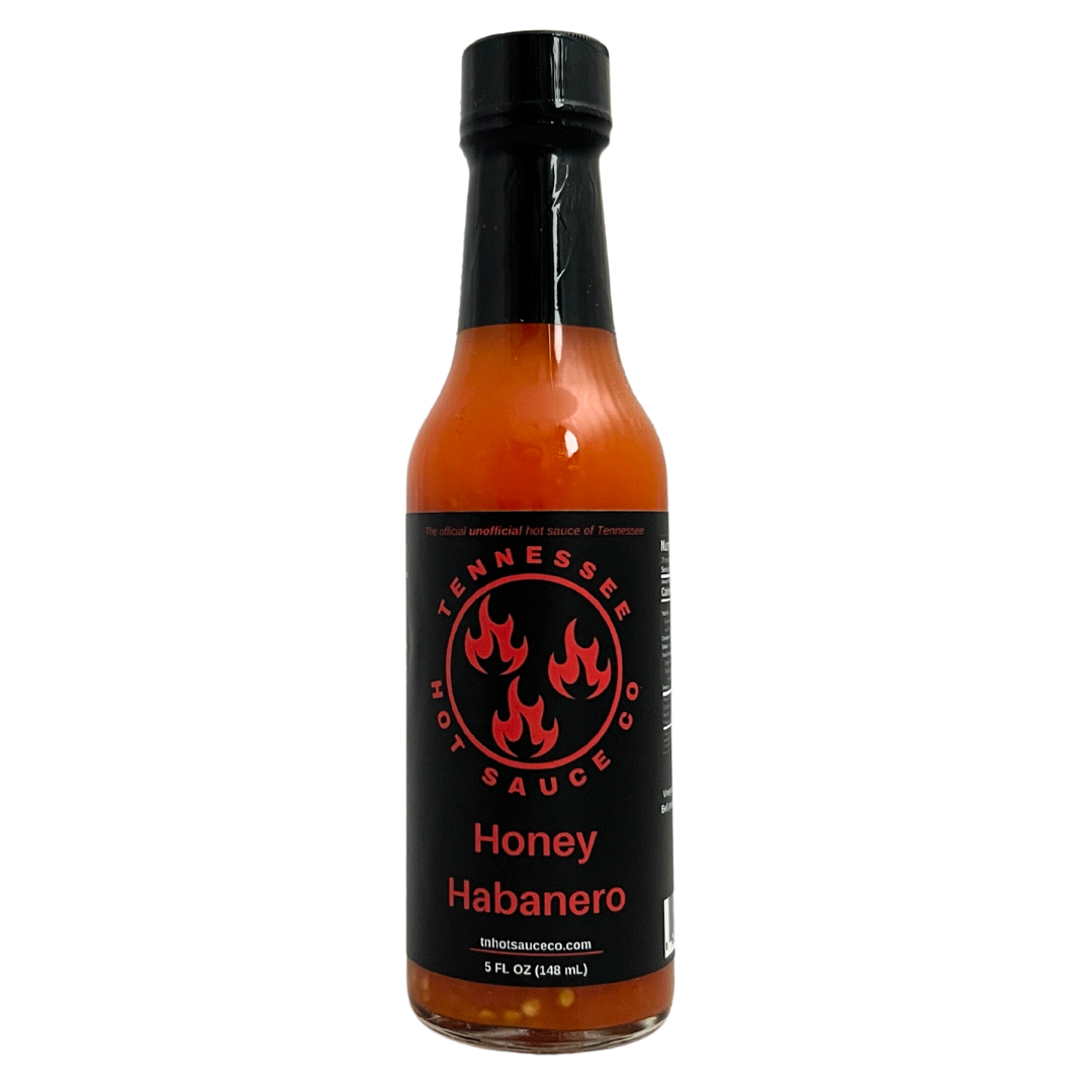 Tennessee Hot Sauce Co. Honey Habanero bottle. Glass bottle with a black label and black cap.