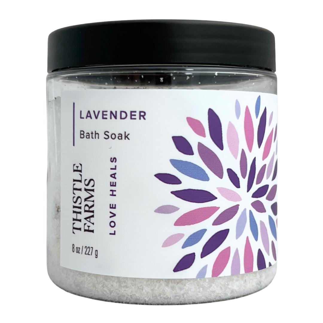 Lavender bath salts in 8 oz plastic jar with black lid purple floral pattern on a white label. 