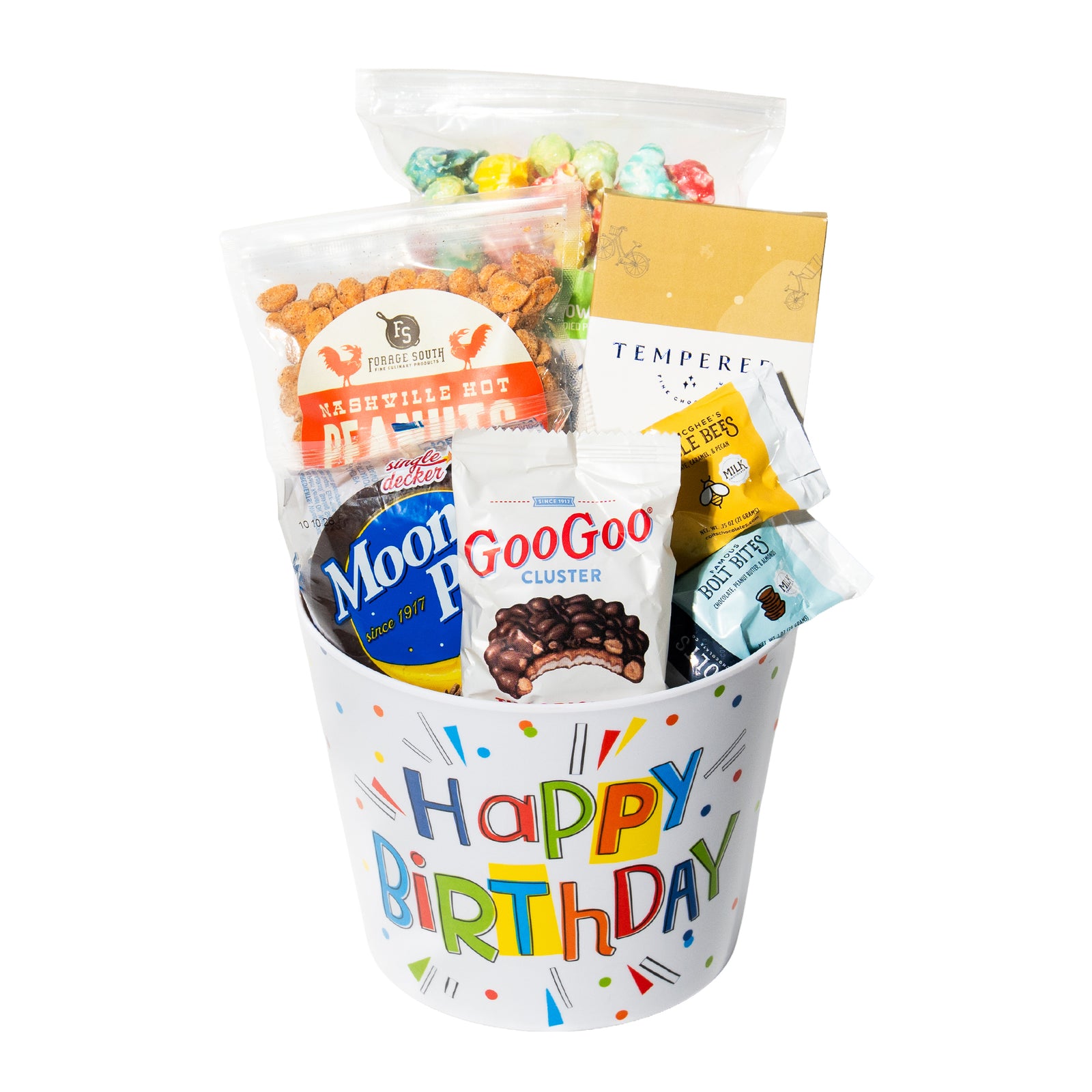 collection of favorite snacks and chocolates in a birthday themed bucket. Final gift presentation is wrapped in cellophane and tied with a bow.  
