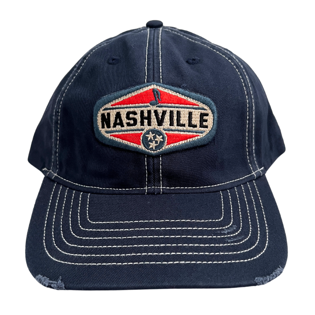 Navy chino hat with white top stitching, embroidered patch says "Nashville" with music note and tristar.