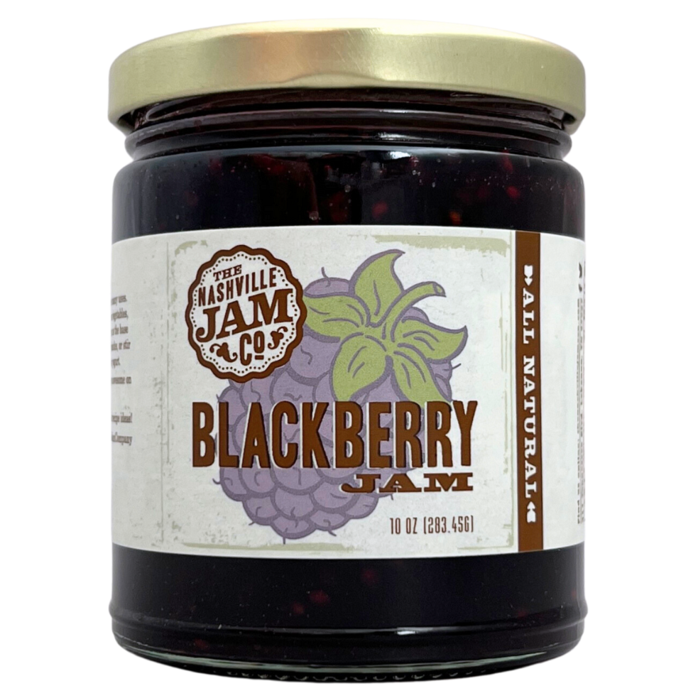 Blackberry jam in 10 oz clear glass jar with gold lid, label has illustration of a blackberry. 