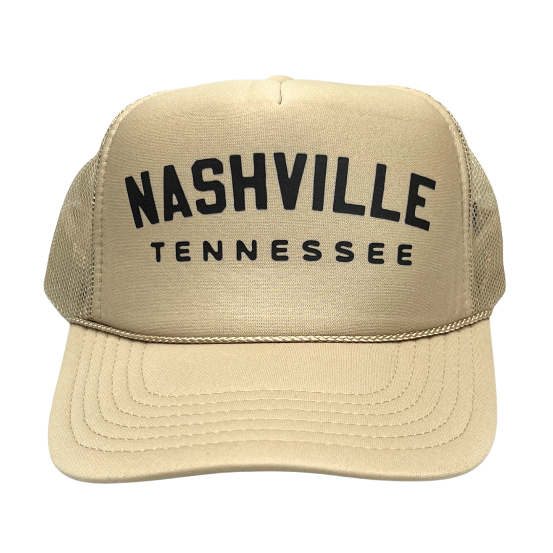 beige fomy trucker hat with breathable mesh sides, with adjustable back. Black lettering. 
