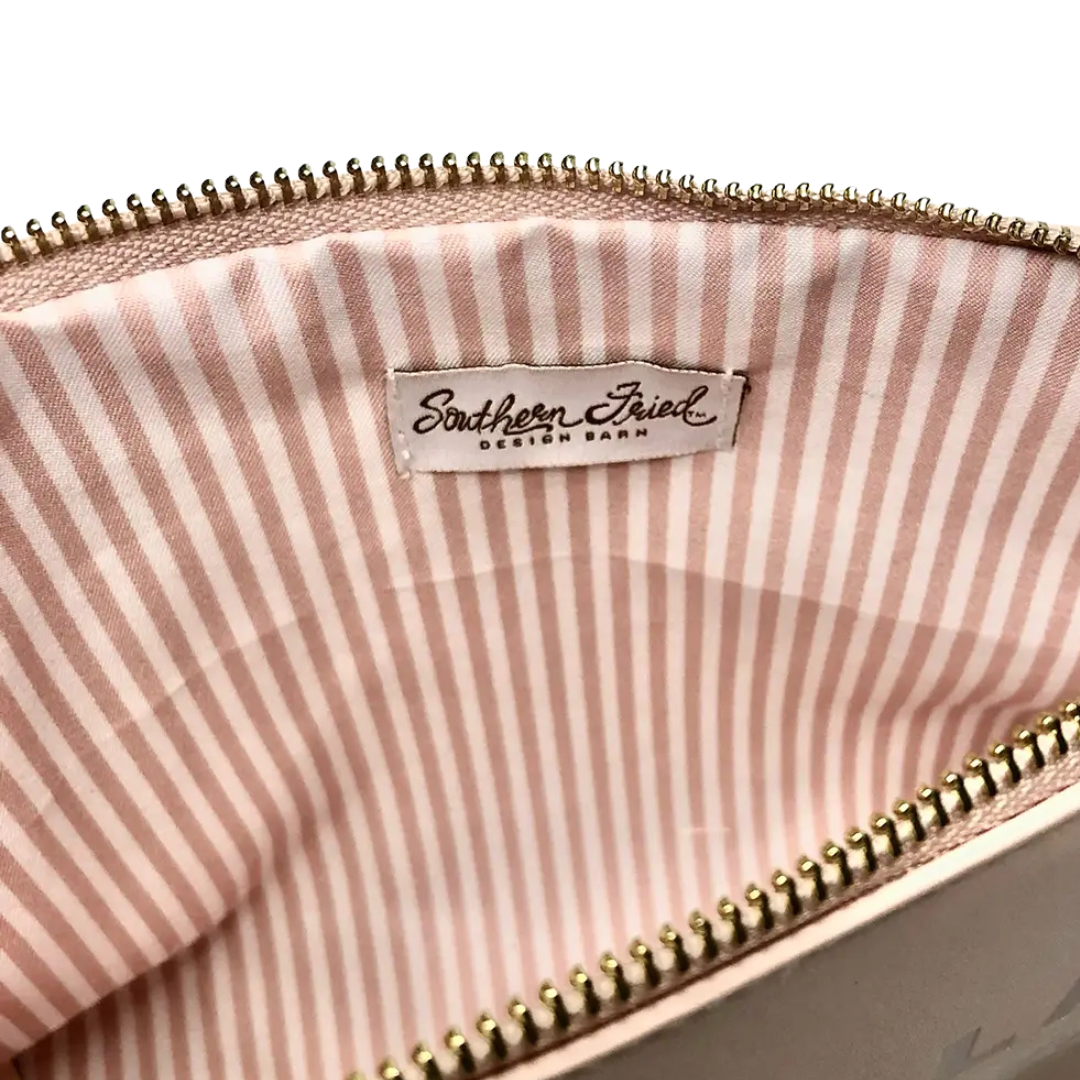 pink faux leather catch all pouch, lined with zipper.