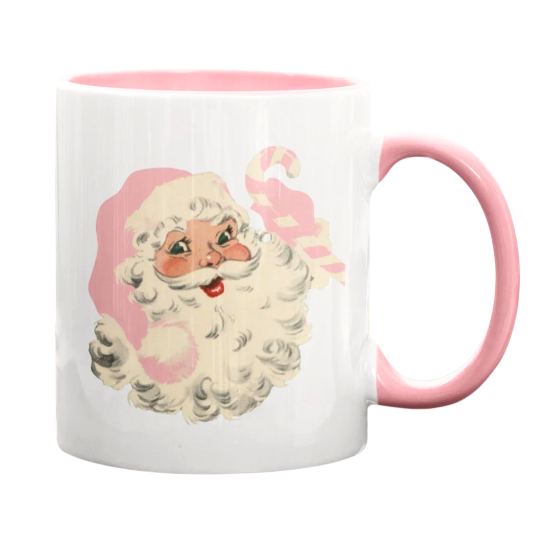 Retro like pink santa mug. Features Santa with pink holding a pink candy cane. Has a pink handle, white cup, and inside the cup is a pink color.