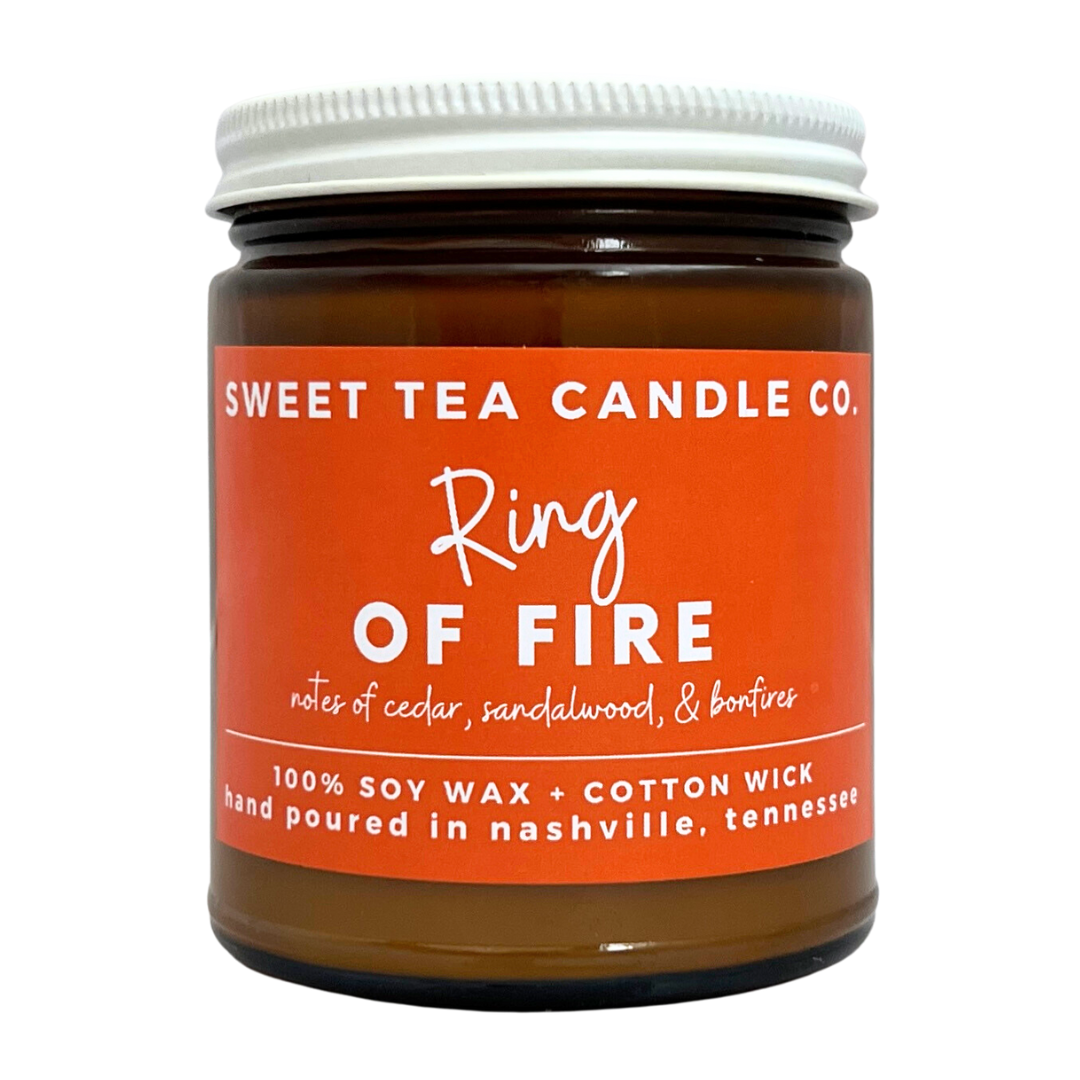 "Ring of Fire" candle in amber jar with lid. Notes of cedar, sandalwood, and bonfires. 