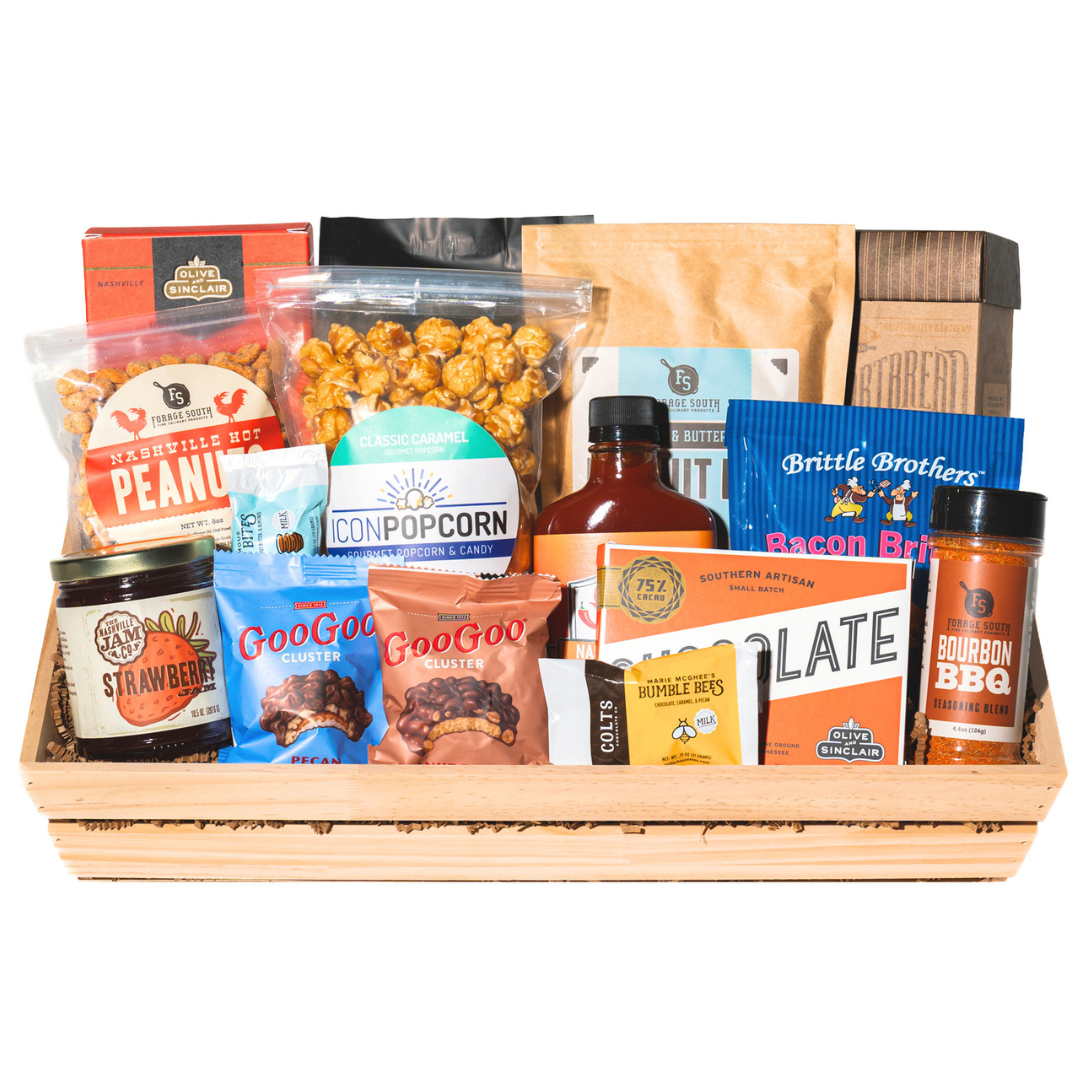 large gift basket full of snacks, hot sauce, jam, seasoning, coffee, biscuit mix.