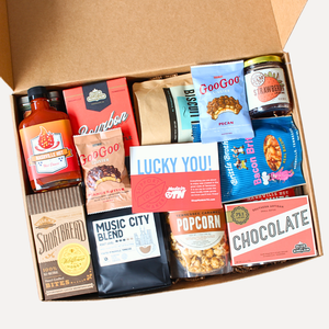 large gift box full of snacks, hot sauce, jam, seasoning, coffee, biscuit mix.