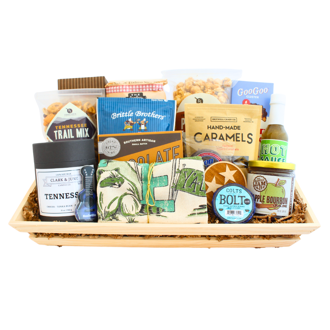 Gift basket full of Tennessee snacks, dry goods, sauce, jam, candle and tea towel. 