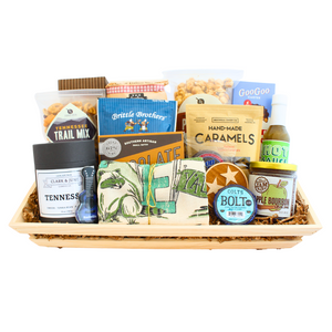Gift basket full of Tennessee snacks, dry goods, sauce, jam, candle and tea towel. 