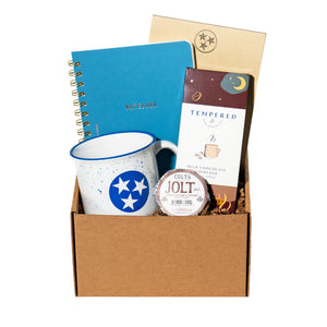 collection of notebook, notepad, mug and chocolates in a gift box. 