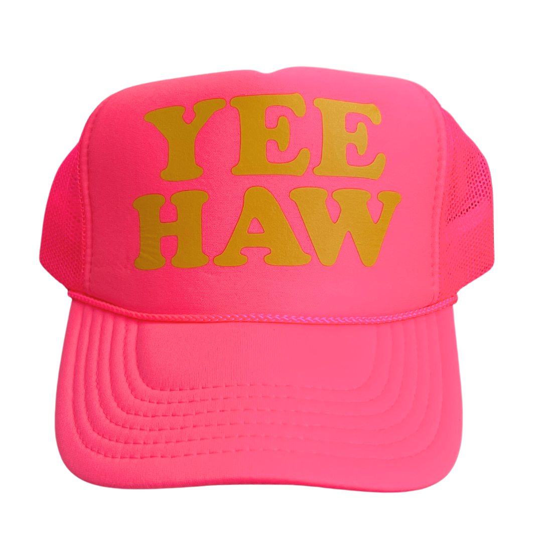 Hot Pink trucker hat with foamy front and mesh sides; says, "Yeehaw" in gold. 