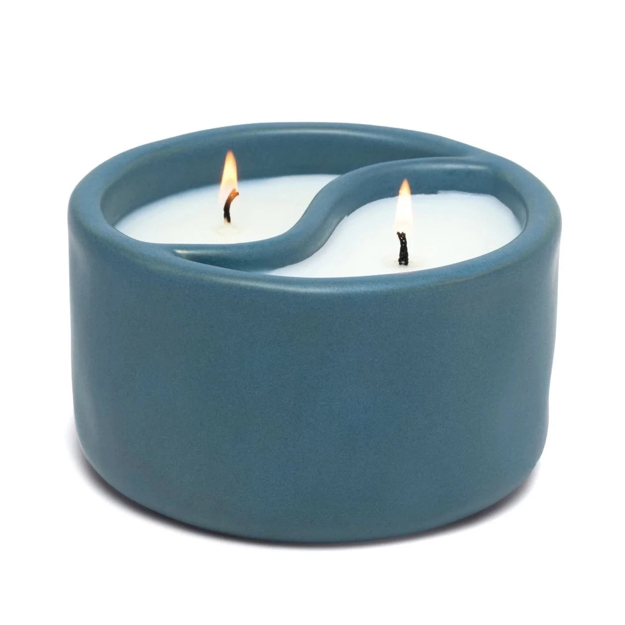 Yin-Yang candle in blue ceramic dish.