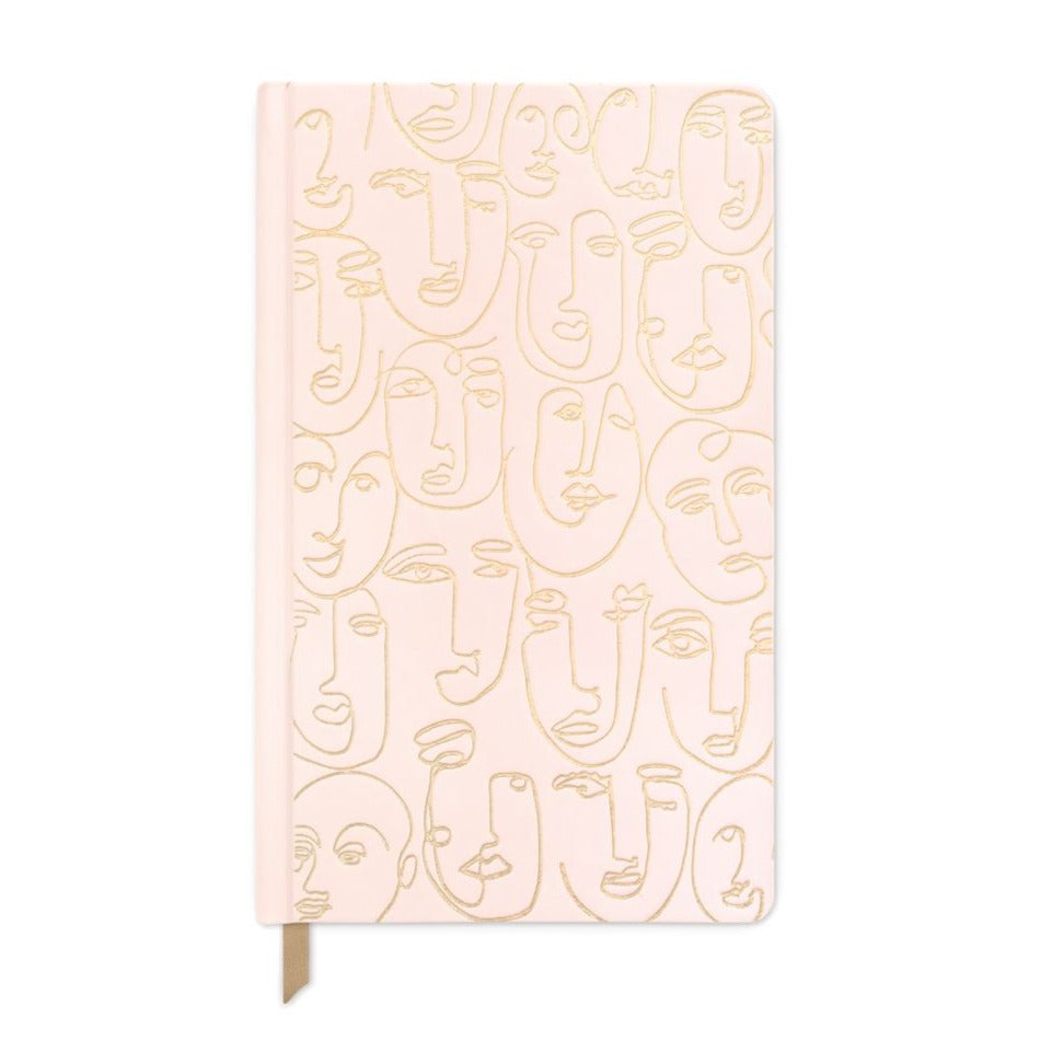 Hardbound lined notebook covered in light pink fabric with gold embossed faces.