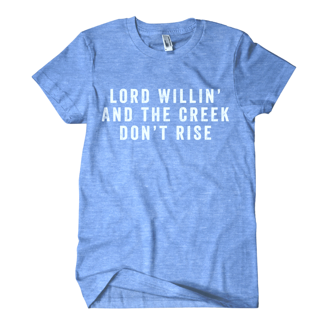 Southern saying "Lord Willin' And The Creek Don't Rise" in white on blue shirt.