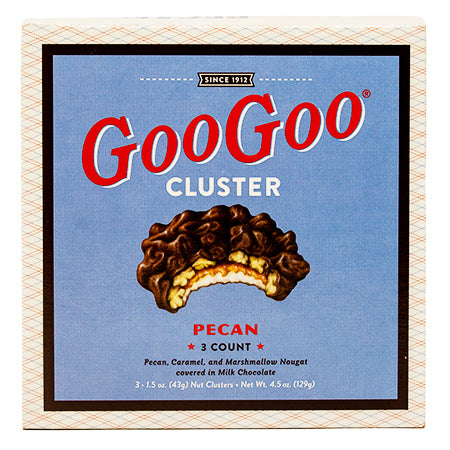  3 GooGoo Cluster candy bars with marshmallow nougat caramel and peanuts covered in chocolate.