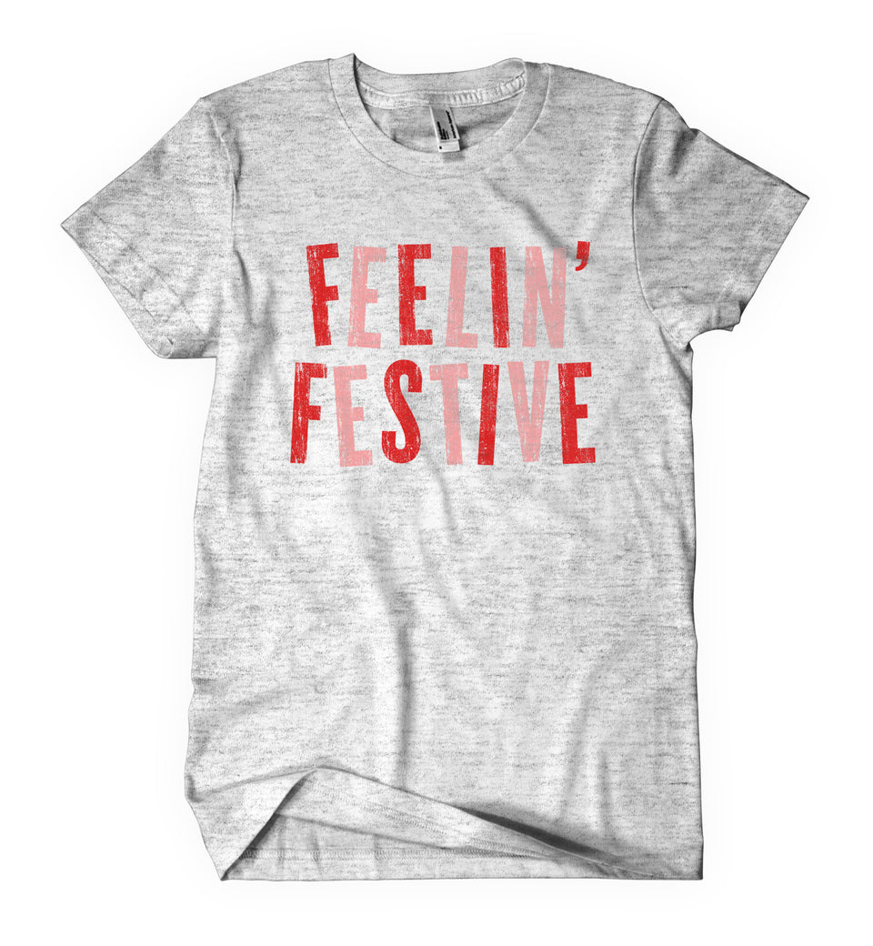Light grey shirt says, "Feelin' Festive" screen-printed in red and pink.  