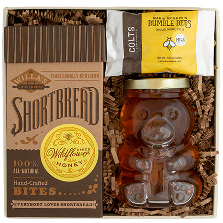 Gift box with honey flavored cookies, chocolate and jar of honey.  