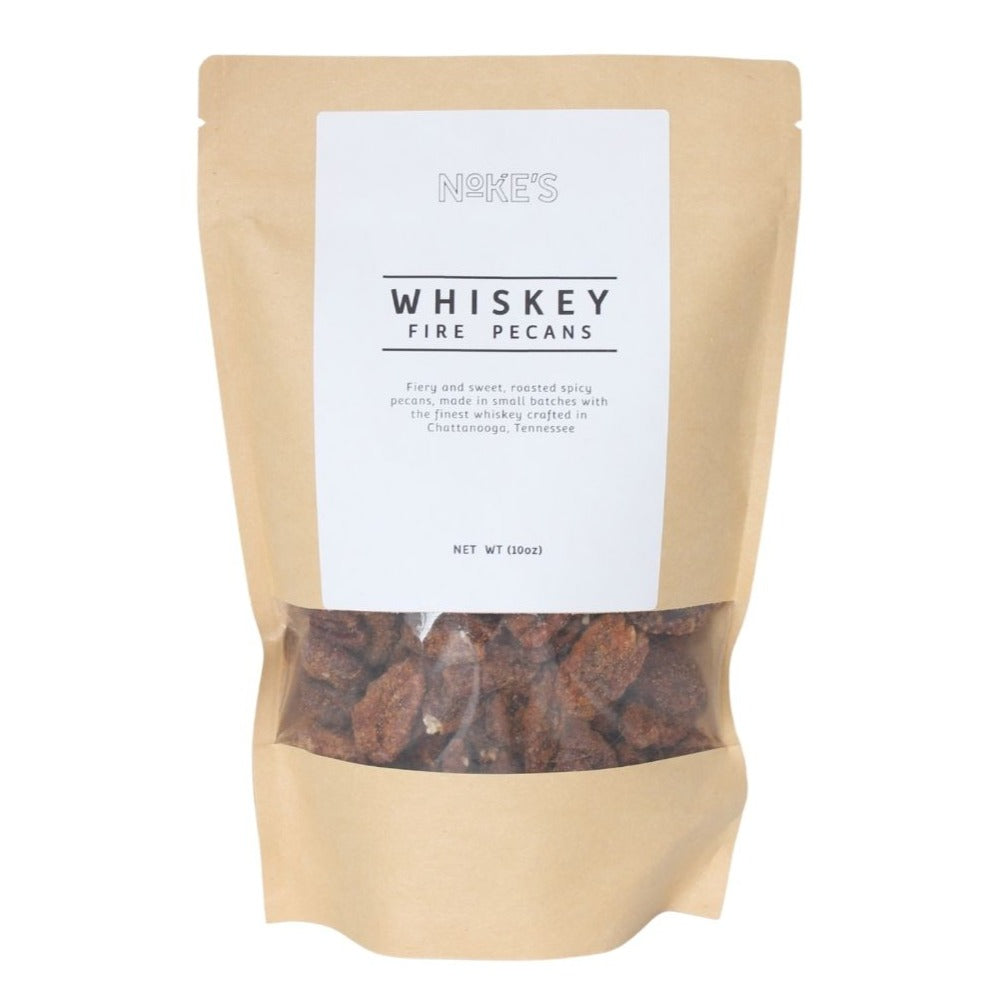 Whiskey Fire Pecans come in a tan resealable bag for easy use. Packaging lists ingredients and source location.
